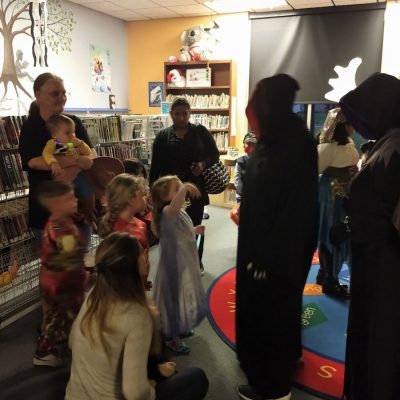 Image of partygoers in Halloween costumes at a party at the Ravenswood library.