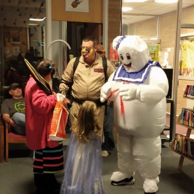 Image of partygoers in Halloween costumes at a party at the Ravenswood library.